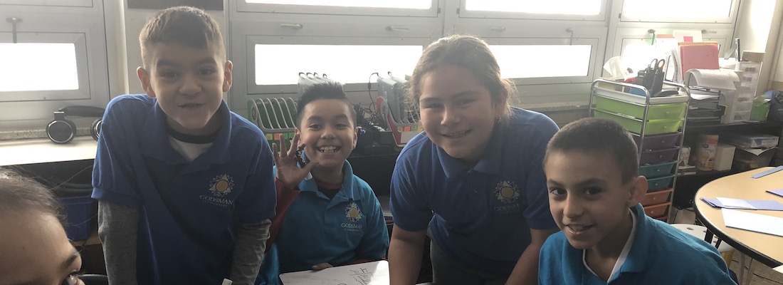 Four students posing in class