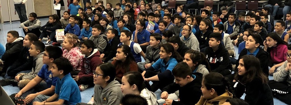 All students sitting on the floor